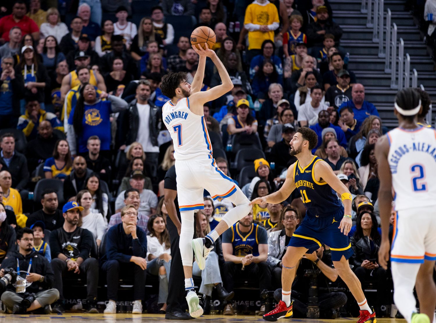 Thunder's Chet Holmgren shoots over Warriors' Klay Thompson.